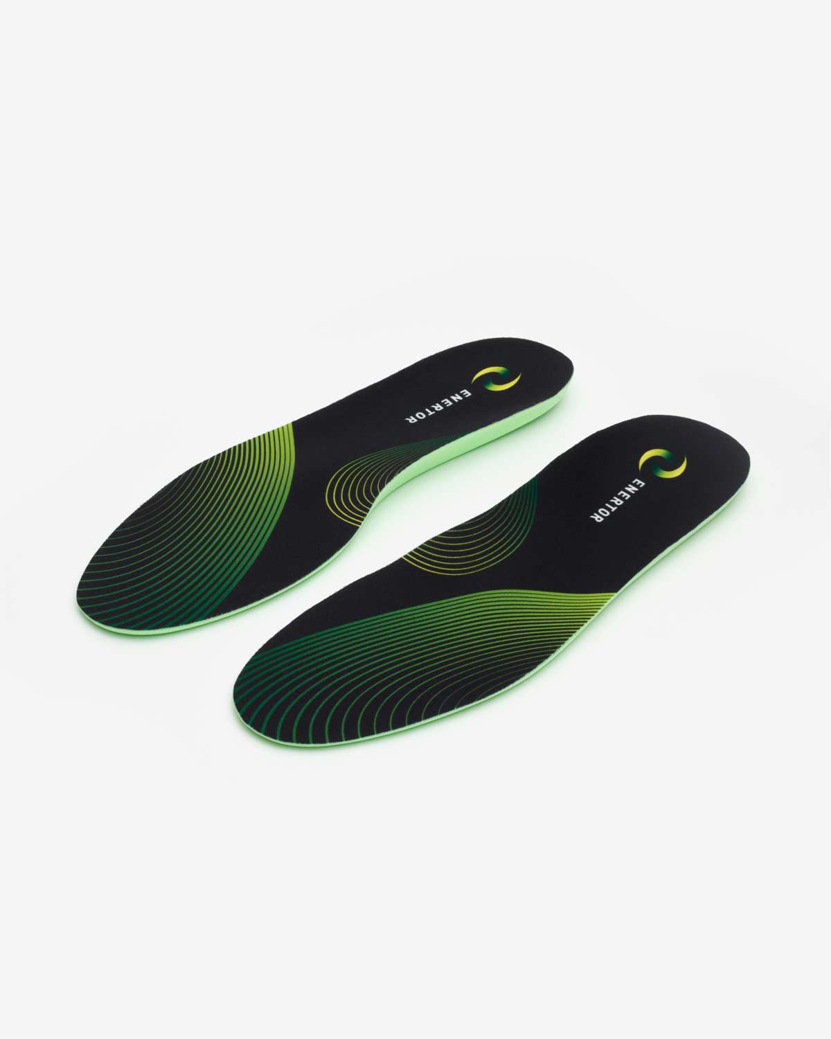 Pair of black and green shoe insoles on a white background