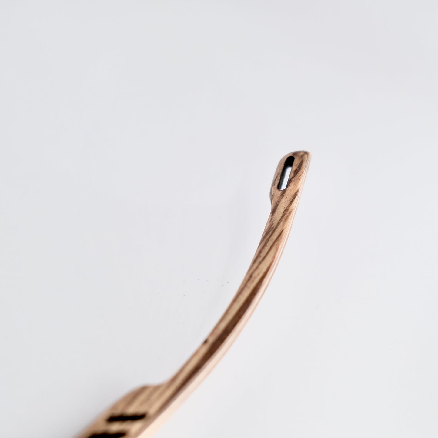 Bronze-colored spoon on a light gray background