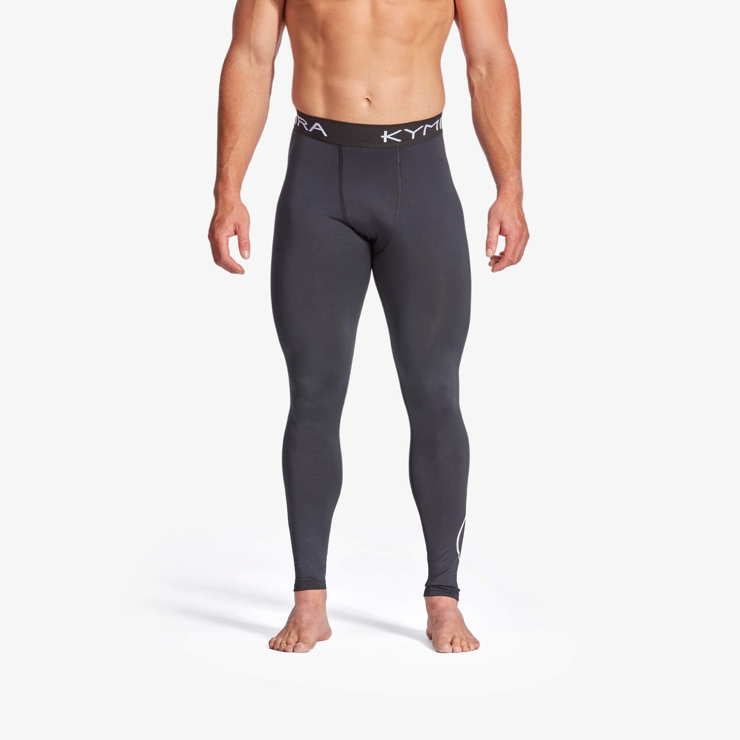 Person wearing gray compression leggings with a white background